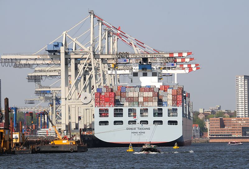Hamburg-Bilder; Fotos aus dem Hamburger Hafen - HHLA Container Terminal Tollerort Containerschiffe am Hafenkai - Containerbrcken, Barkassen Hafenrundfahrt 11_12_6668 Blick auf das Heck des hoch beladenen Containerfrachters COSCO TAICANG und den Containerbrcken des Tollerort Contaner Terminals. Die TAICANG hat eine Lnge von 348m und Breite von 45,6m - das Containerschiff hatte seinen Stapellauf 2009 und kann ca. 10000 Standard-Container Ladung an Bord nehmen. Zwei Barkassen mit Hamburg-Touristen sind auf ihrer Rundfahrt durch den Hamburger Hafen. Im Hintergrund am Elbufer Gebude in Hamburg-Altona.