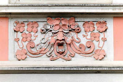 7465 Jugendstilstuck - Figur mit Blüten - Bauschmuck an einer Fassade in Hamburg Eimsbüttel.